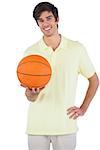 Happy man holding a basket ball on a white background