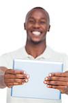 Tablet pc held by smiling man on white background