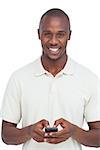 Smiling man using his mobile phone on a white background