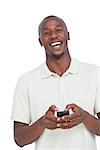 Laughing man with mobile phone on a white background