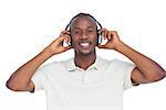 Happy man listening music with headphones on a white background