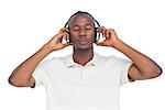 Man with eyes closed listening to music with headphones