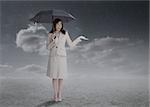 Businesswoman holding an umbrella during a stormy weather