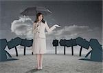 Businesswoman in front of signs holding her umbrella and smiling