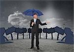 Businessman showing signs and a city and holding blue umbrella