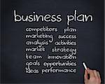 Hand writing words about business plan on chalkboard