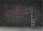 Businessman standing on a ladder and drawing a red line through black maze on a wall