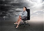 Businesswoman sitting in middle of opposite weather settings in a swivel chair