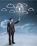 Businessman holding a floating padlock around clouds on the background