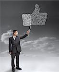 Businessman holding a giant thumb up from the social network