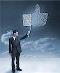 Businessman holding a blue giant thumb up from the social network