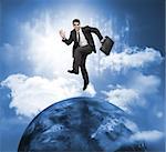 Businessman jumping over a planet with the sky on the background