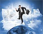Businessman jumping over a planet with drawings floating around