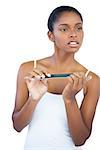 Brunette using nail file on white background