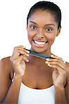 Cheerful woman holding nail file on white background