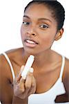 Woman holding her lip balm on white background