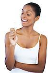 Happy woman holding her lip balm on white background