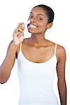 Smiling woman smelling her lip balm on white background