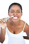 Woman brushing her teeth on white background