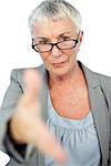 Serious woman with glasses presenting her hand for handshake on white background