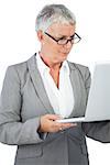 Businesswoman with glasses watching her laptop on white background