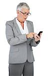 Businesswoman with glasses texting a message on her mobile phone on white background