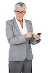 Businesswoman with glasses using her mobile phone on white background