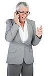 Excited businesswoman calling someone with her mobile phone on white background