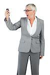 Furious businesswoman screaming during a call on white background