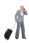 Businesswoman with her luggage and calling someone on white background