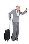 Furious businesswoman screaming during a call with suitcase on white background