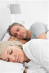 Couple sleeping peacefully at home in bed