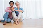 Happy young housemates showing their new house keys and smiling at camera