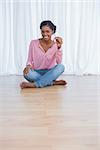 Cheerful young woman showing her new house keys and smiling at camera