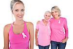 Three happy women wearing pink tops and breast cancer ribbons on white background