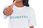 Woman wearing volunteer tshirt and giving thumb up on white background