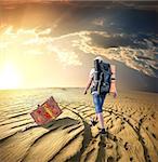 Man with a backpack traveling in the desert