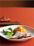 Sliced Turkey Breast with Brussels Sprouts and Mashed Sweet Potatoes for Thanksgiving Dinner on Red Background