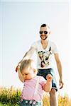 Father and Baby Daughter Walking Outdoors, Mannheim, Baden-Wurttemberg, Germany