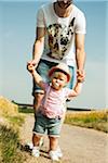 Father and Baby Daughter Walking Outdoors, Mannheim, Baden-Wurttemberg, Germany