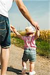 Father and Baby Daughter Walking Outdoors, Mannheim, Baden-Wurttemberg, Germany