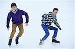 Two boys ice-skating on a frozen lake