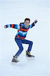 Boy ice-skating on a frozen lake