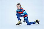 Boy ice-skating on a frozen lake