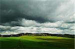 Storm clouds over rolling hills in spring, Vogtland, Saxony, Germany, Europe