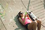 Teenage Girl Listening to MP3 Player in Skatepark, Feudenheim, Mannheim, Baden-Wurttemberg, Germany