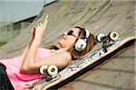 Teenage Girl Listening to MP3 Player in Skatepark, Feudenheim, Mannheim, Baden-Wurttemberg, Germany