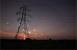 Silhouette of electrical towers at sunset