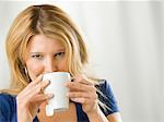 Mid adult woman drinking from cup, portrait