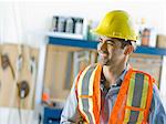 Mid adult construction worker smiling